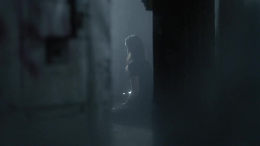 A woman sitting in a building on her knees