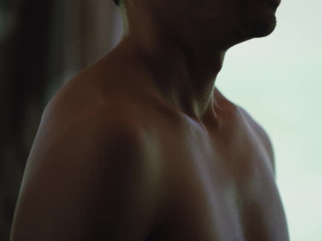 A footage of a person standing without putting on cloths