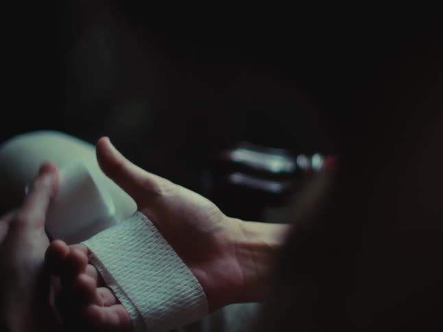 A footage of a person wrapping a tissue on the hand