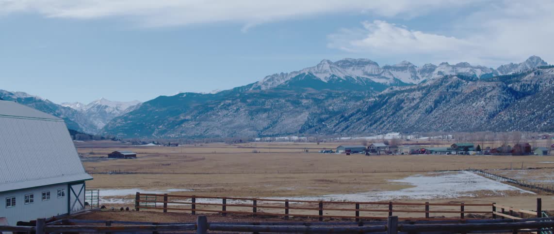 A large ranch is near the mountain