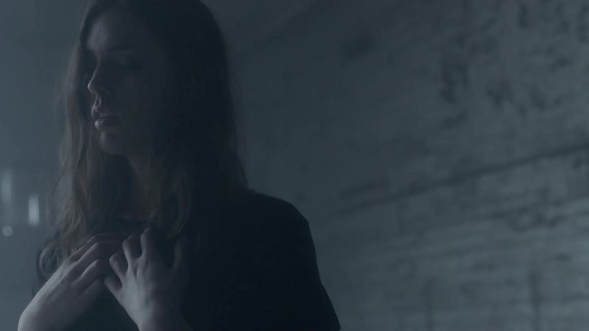 A woman with hands on her chest breathes deeply