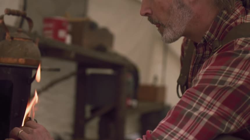 A footage of a man lighting a fire