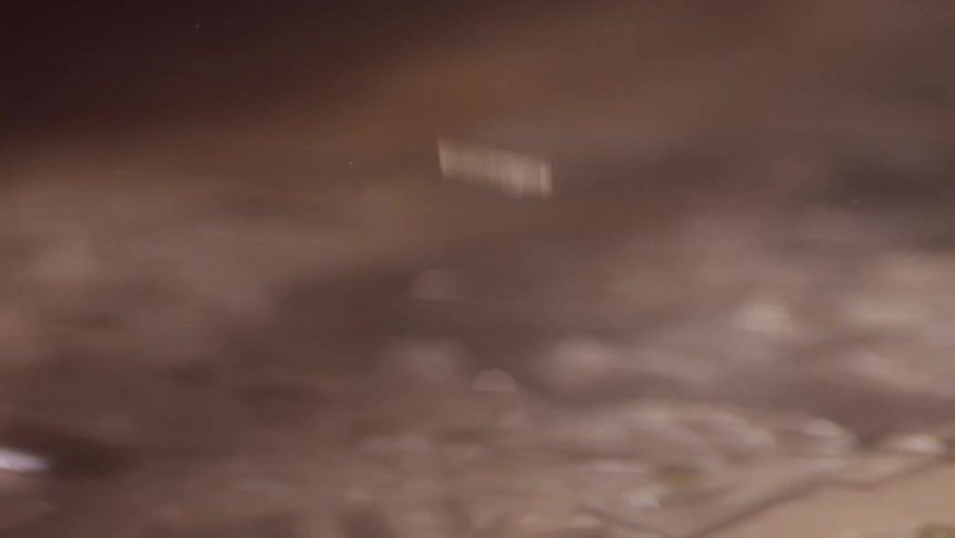 Glass and mirror shards drop onto a floor
