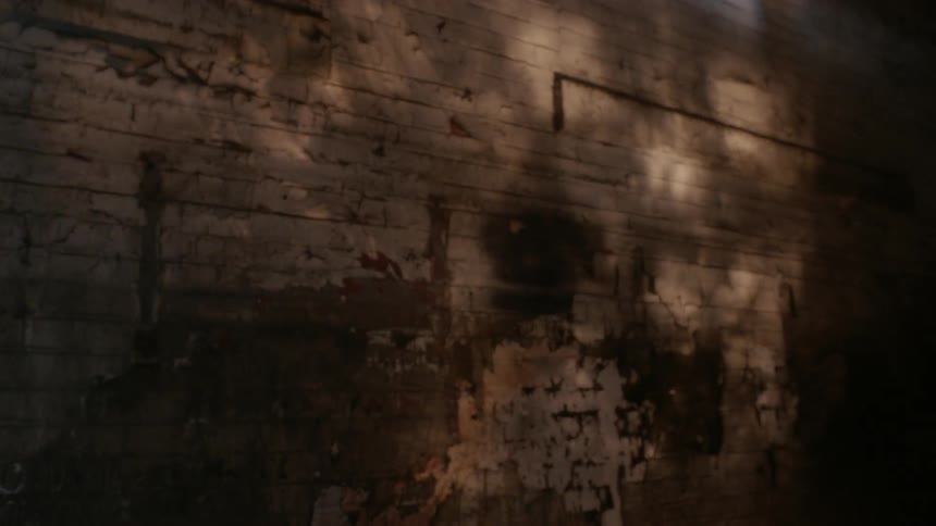 Shadow and light play on an interior brick wall