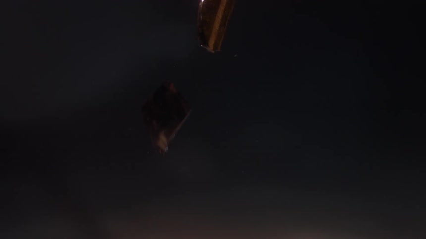 A person slowly drops glass in their hands