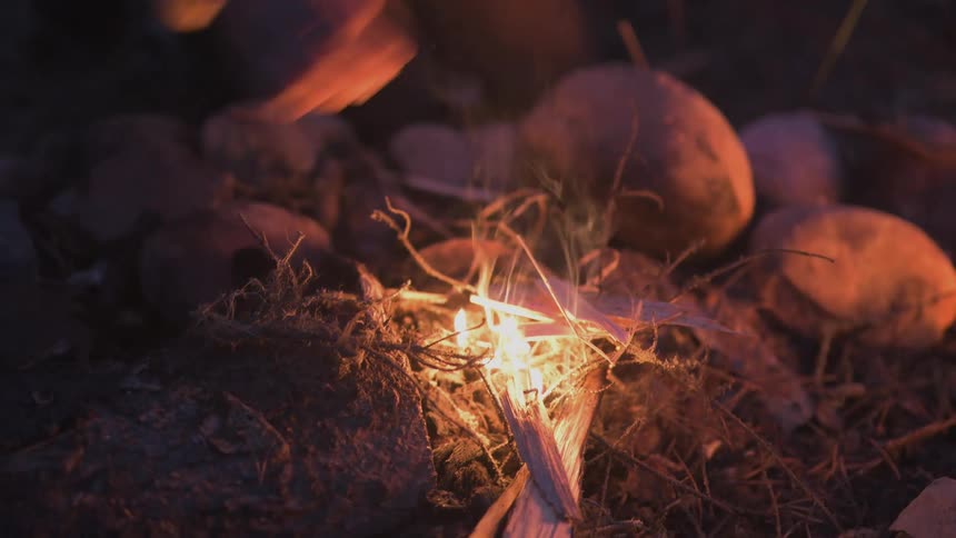 A footage of a person lighting up a fire