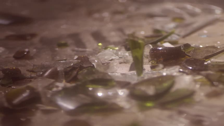 Shards of glass fall to the ground