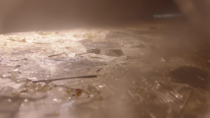 Shattered glass covers the ground