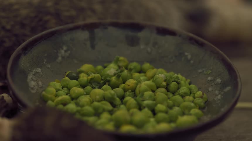 The bowl is full of peas