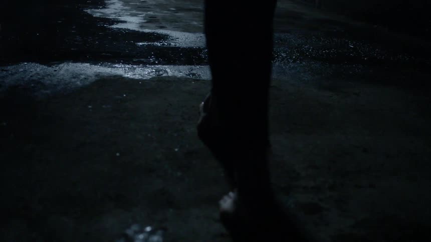 A person is walking in this dark area
