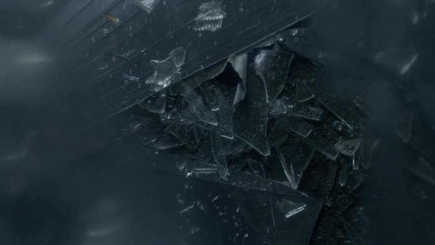 Shards of glass lay on the ground