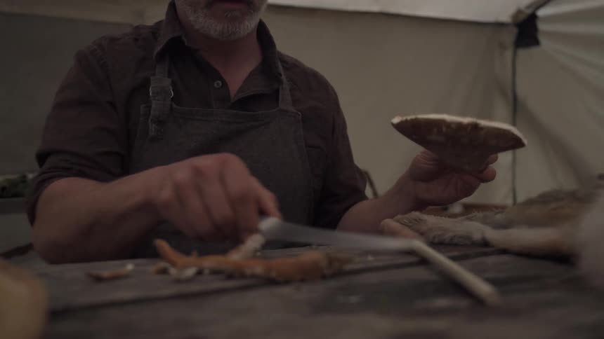 A footage of a man slicing with a knife