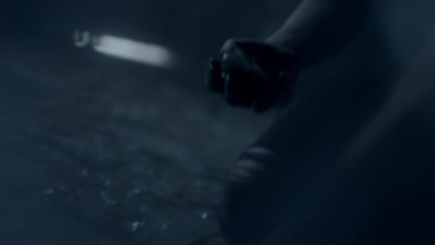 A person is picking up glass from the ground