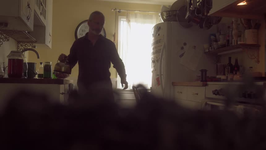 A footage of a man cooking in the kitchen