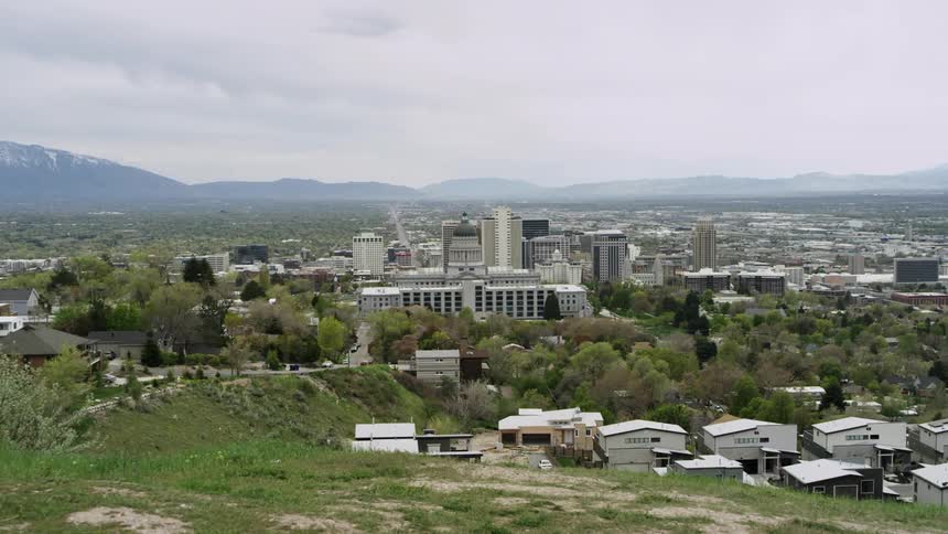 The city ahead has mountains in the distance
