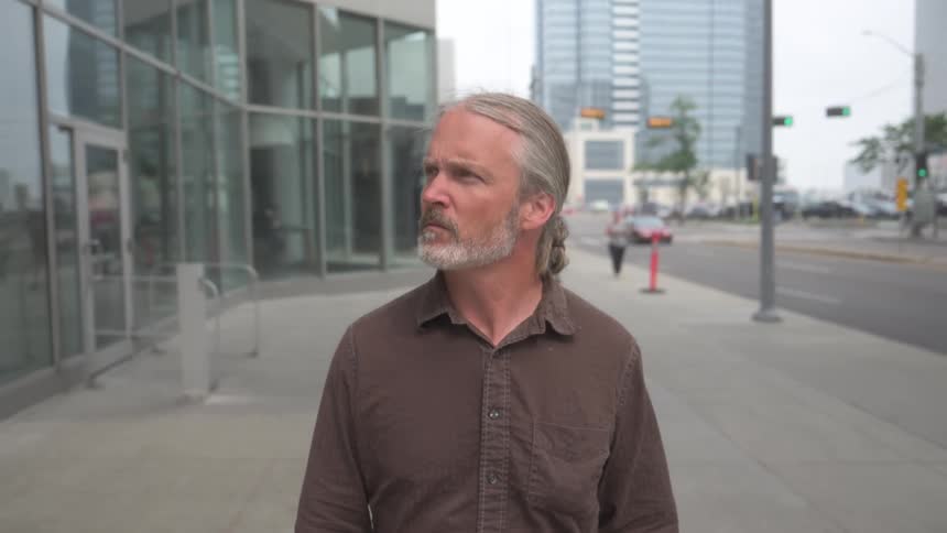 A footage of a man walking by the walkway
