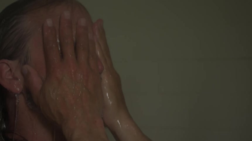 A man is showering in the bathroom
