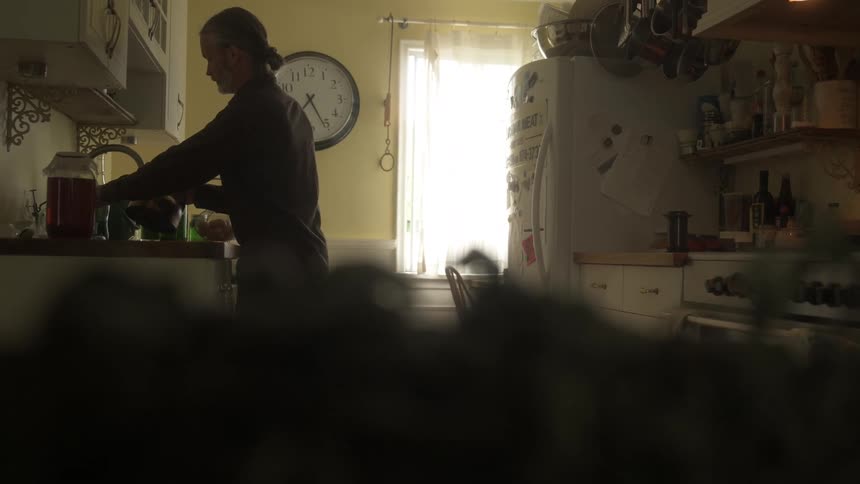 A footage of a person cooking in the kitchen