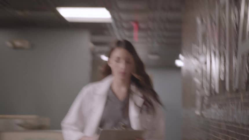 A doctor walks down the hall in the hospital