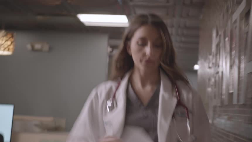 A woman is walking through the hospital