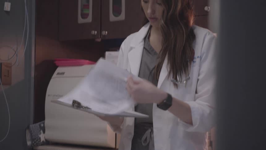 A footage of a doctor in an office going through some documents