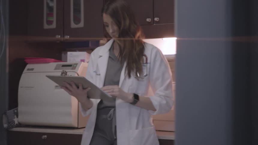 The doctor reads paperwork in the hospital