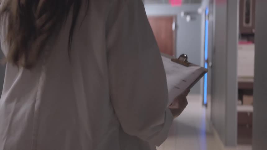A footage of a lady walking the corridor