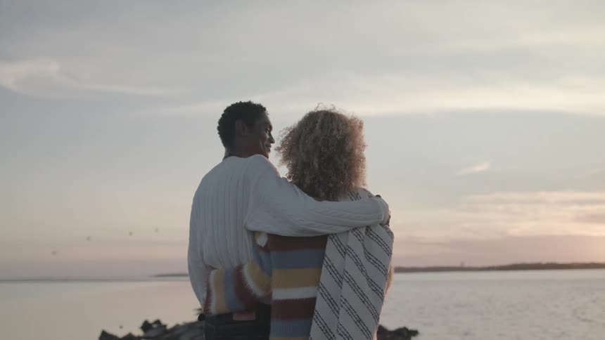 A footage of couples standing by the shore