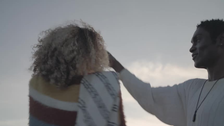 A man and woman dance by the lake