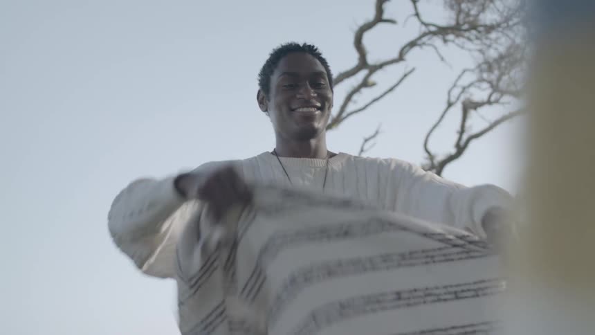A clip of a man holding a scarf