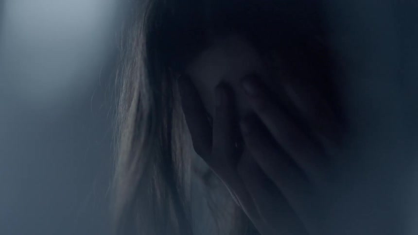 A woman is crying covering her face