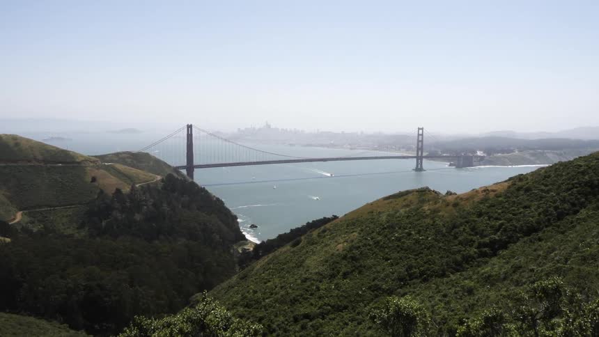 A bridge can be seen ahead on top of these mountains