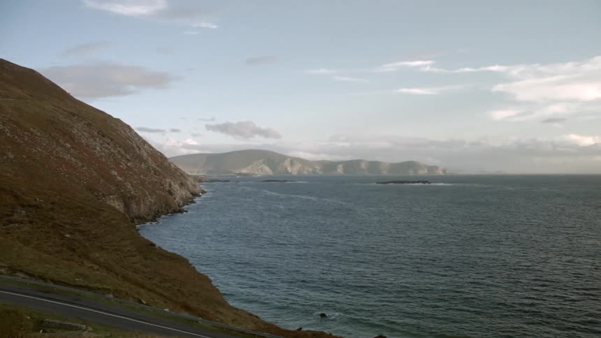 The shore is surrounded by rocky hills