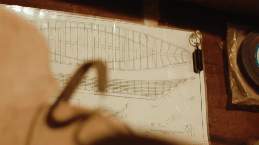 A blueprint tacked to a wall