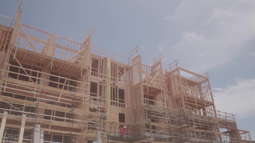 A truck passes by the construction site