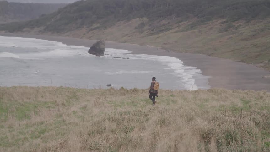 A footage of a person walking at the seashore