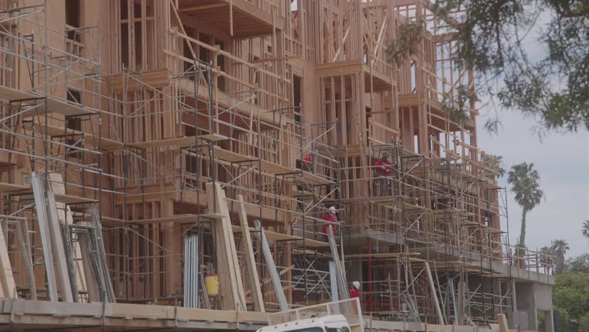 Workers are on the scaffolding of the construction site