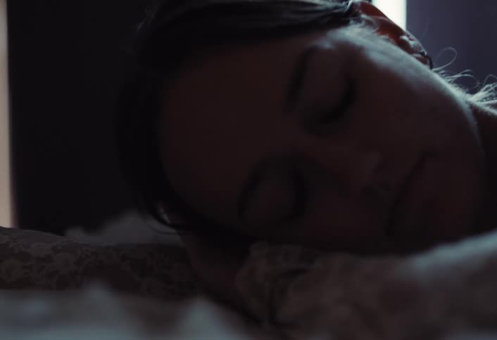 A footage of a female laying on a bed
