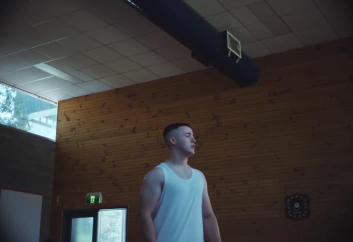 A man walks over to the center of the room