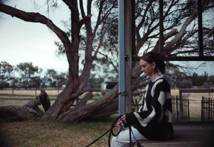 A footage of a lady sitting outdoor