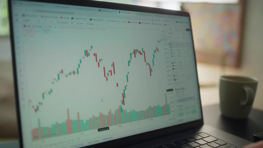 A person scrolls through a graph on his laptop