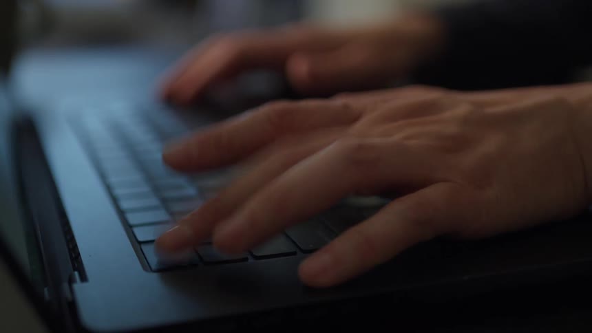A person taps his keyboard then types