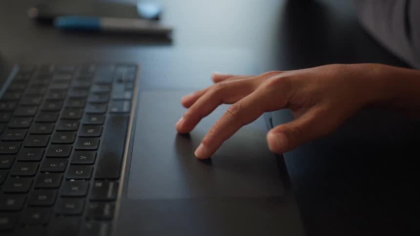 A person is using the touchpad on a laptop