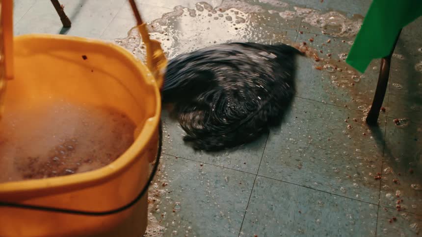 A mop is used to mop up a mess in the kitchen