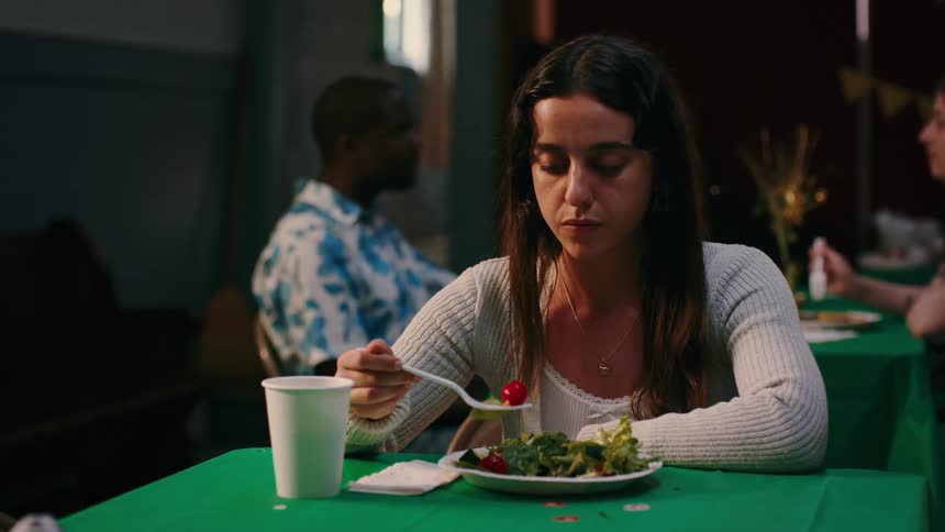 A woman is eating a salad