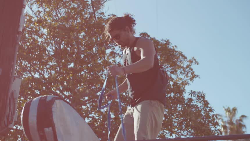 A man secures an item with a rope