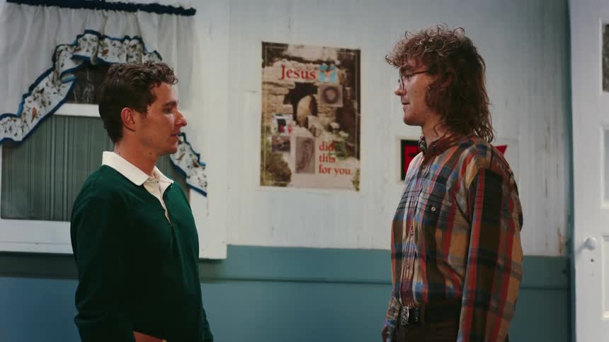 A footage of two men smiling and having a conversation