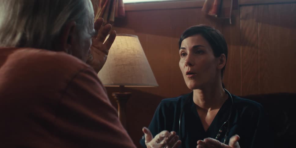 A footage of a lady giving an home care to an adult man