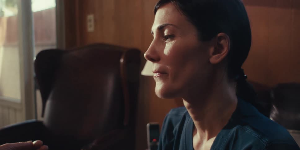 Female medical professional talks to a patient during a home healthcare visit