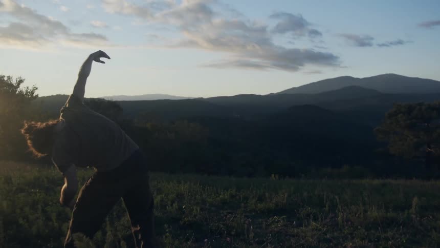 A person stretching in a field
